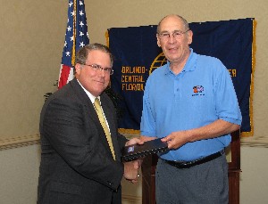 In October, Dr. Michael R. Macedonia (l), vice president and chief scientist for Science Applications International Corporation, accepts a TechNet Orlando memento from Col. Fred Eisele, USA (Ret.), chapter vice president for programs.